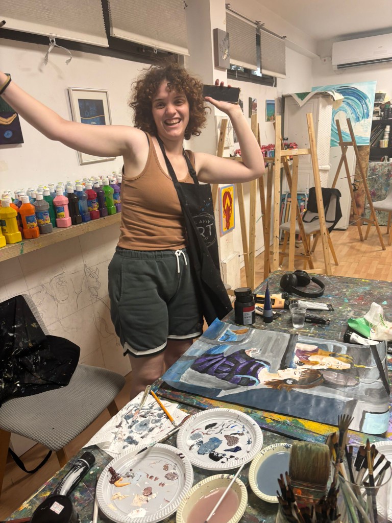 Devorah celebrating a finished The Woman on the Bus painting during a studio visit