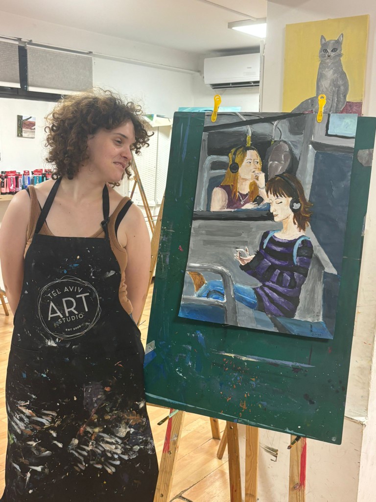 Devorah beside her The Woman on the Bus painting during a studio visit